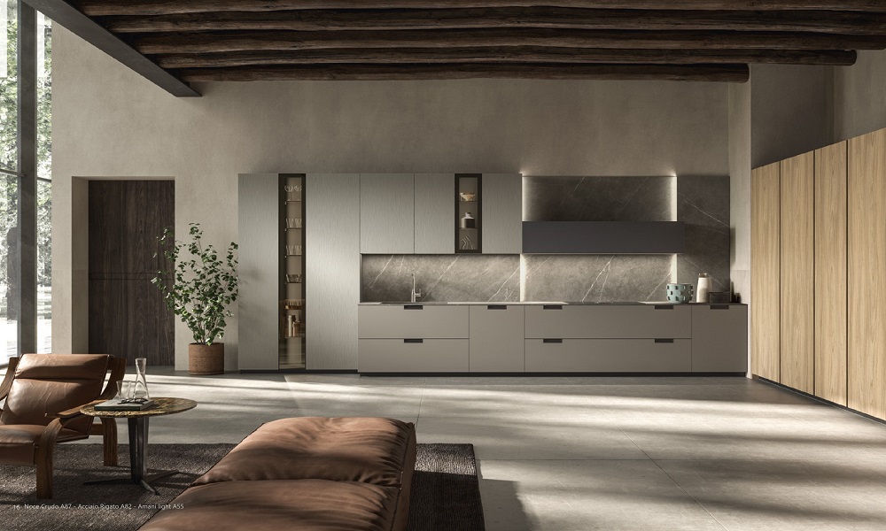 Atelier kitchen by Aster Cucine featuring matte cabinetry, integrated stone backsplash, natural wood panels, and a minimalist open-plan living space.