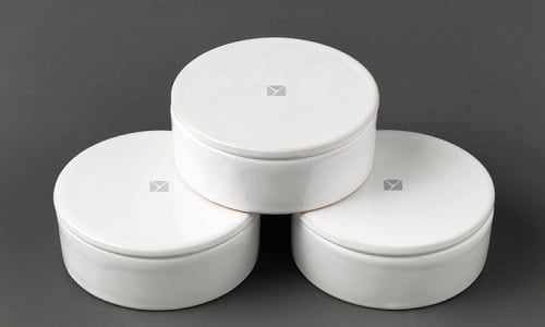 Minimalist round white kitchen storage containers by Aster Cucine with smooth matte finish, designed for organized luxury interiors.