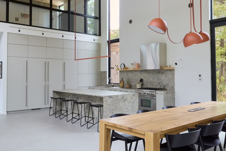 Modern open-concept kitchen in Northern New Jersey with custom cabinetry, stone island, and sculptural pendant lighting.