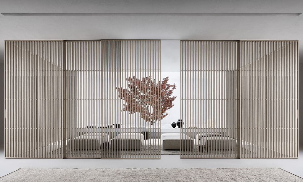 Sliding glass doors separating living space and balcony, enhancing natural light and open-plan desig.