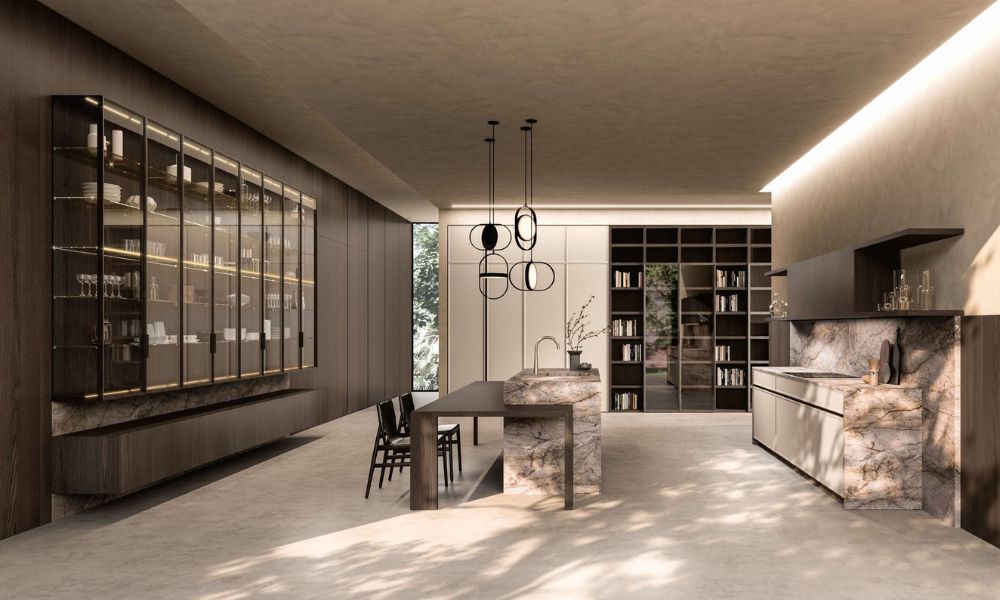 Quintessence kitchen by Aster Cucine featuring refined wood cabinetry, glass display units, stone island, and integrated lighting in a modern luxury interior.