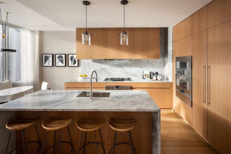 Modern wood kitchen in New York Cityy with custom cabinetry, stone island, integrated appliances, and warm natural finishes.