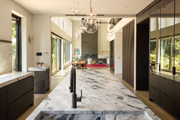 Modern farmhouse kitchen with reclaimed wood island, cement-finish cabinetry, quartzite countertops, and integrated appliances, custom designed by Urban Homes.