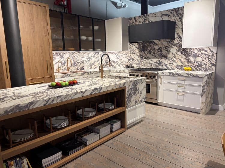 Urban Homes modern kitchen with marble countertops and sleek cabinetry.
