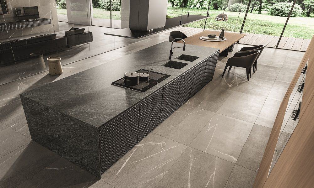 Aster Cucine Pure Glam modern Italian kitchen with stone island, textured cabinet fronts, and integrated cooktop in luxury contemporary home.